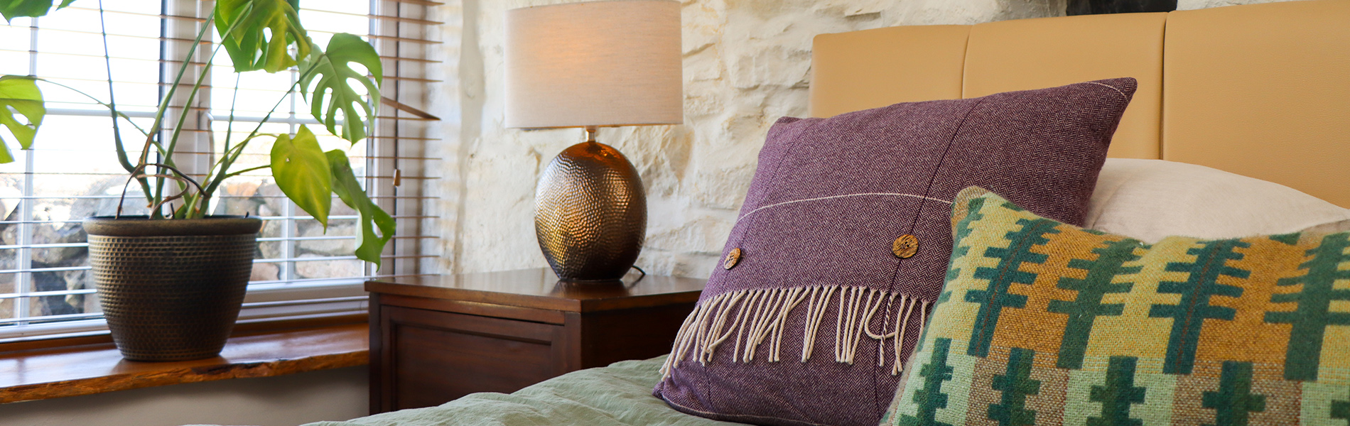 bedding and window in one of the rooms
