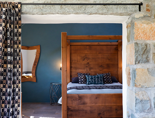 bedroom with blue wall and large wooden bed