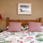 double bed with patterned sheets and pillows