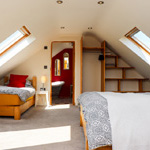 two single beds and door leading to bathroom