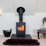 small log burner with fire lit