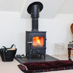 log burner lit with chair