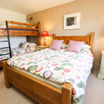 double bed and bunk bed in a room