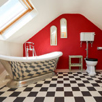 bathroom with 'chessboard' tiles, and large bath