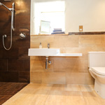 bathroom with open shower, sink and toilet