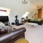 sofas, television and log burner in the lounge