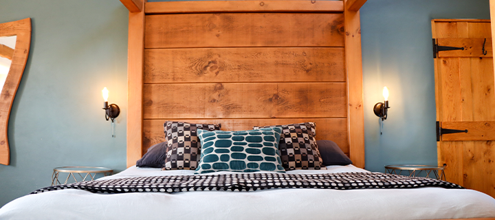 bed decorated with blue blanket and cushions